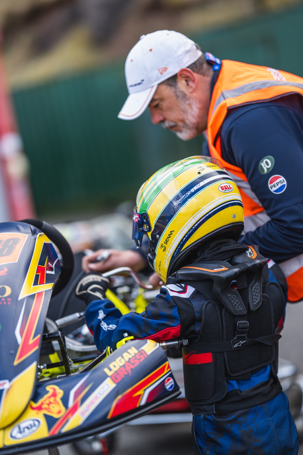 Logan Grassi in his kart with his father preparing for a race