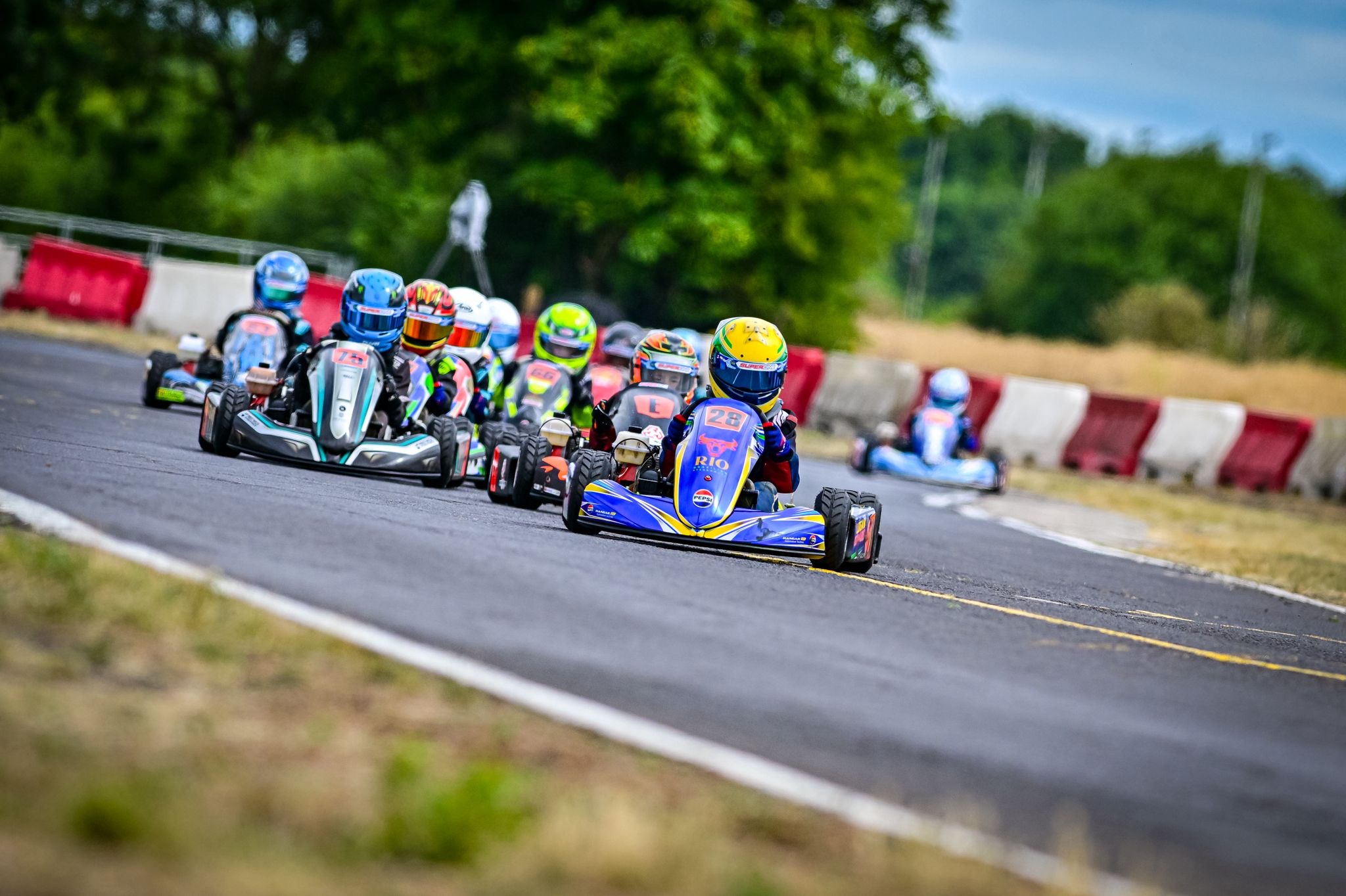Logan Grassi leading a close group of karts